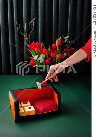 A luxurious dessert gift box containing heart-shaped and cube-shaped cakes, accompanied by a small wooden hammer A luxurious dessert gift box containing heart-shaped and cube-shaped cakes, accompanied by a small wooden hammer 129058451