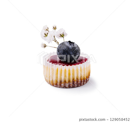 Delicious dessert with blueberry topping and delicate floral decoration 129058452