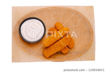Delicious breaded cheese sticks served with creamy dipping sauce Delicious breaded cheese sticks served with creamy dipping sauce 129058651