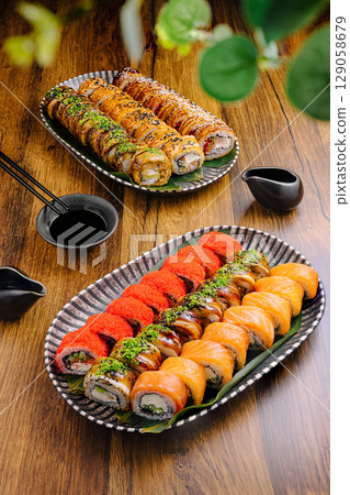 Sushi rolls display beautifully arranged on plates in a warm setting 129058679