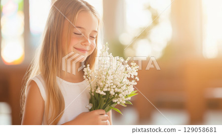 Chrismation symbol with young girl in pure white dress holding flowers 129058681