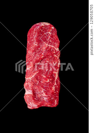 Raw beef cut showcased against a dark background for culinary presentation Raw beef cut showcased against a dark background for culinary presentation 129058705