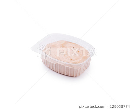 Creamy dipping sauce in a clear container ready for serving snacks 129058774