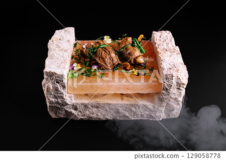 Culinary presentation of grilled seafood on Himalayan salt block Culinary presentation of grilled seafood on Himalayan salt block 129058778