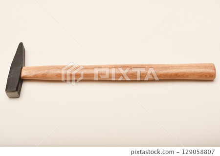 A small hammer with a wooden handle. A hammer on a white background. 129058807