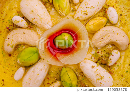 Deliciously arranged traditional Indian sweets on a decorative plate 129058878