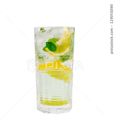 Refreshing mint and lemon drink served in a tall glass with ice Refreshing mint and lemon drink served in a tall glass with ice 129058890