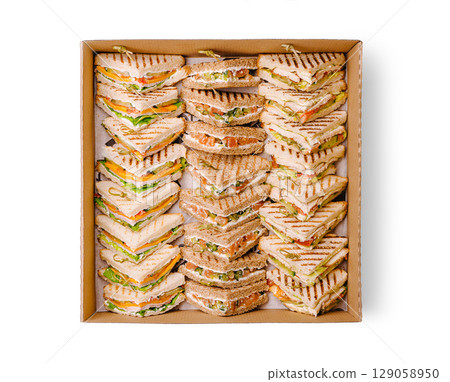 Delicious assortment of gourmet sandwiches arranged in a square box 129058950