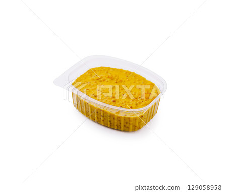 Savory mustard condiment in clear container with rich yellow hue Savory mustard condiment in clear container with rich yellow hue 129058958