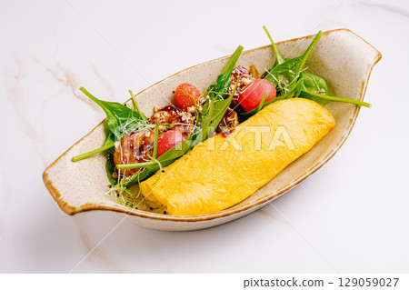 Delicious omelet served with fresh greens and grapes in a modern setting Delicious omelet served with fresh greens and grapes in a modern setting 129059027