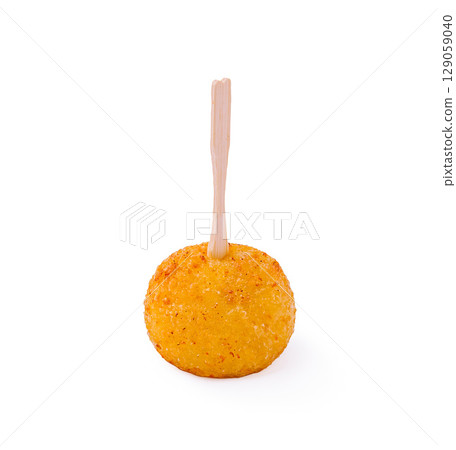 Crispy golden snack ball on a stick ready to be enjoyed at a fair 129059040
