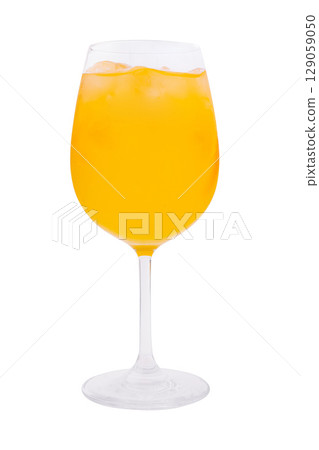 Bright yellow drink served in a glass with ice for a refreshing experience 129059050