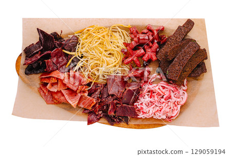 Assorted dried meats and noodles arranged on a serving board Assorted dried meats and noodles arranged on a serving board 129059194