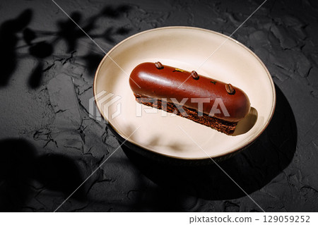 Delicious chocolate dessert served on a minimalist plate in a cozy setting 129059252