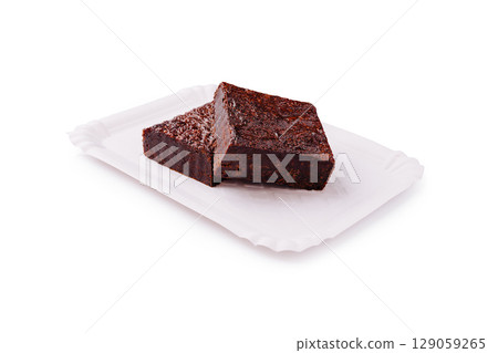 Deliciously rich chocolate brownies on a white plate Deliciously rich chocolate brownies on a white plate 129059265