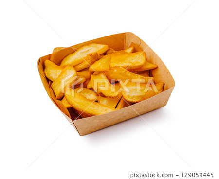 Crispy potato wedges served in a cardboard container at a casual dining setting 129059445