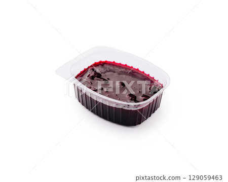 Rich berry jelly in a clear plastic container ready for serving 129059463