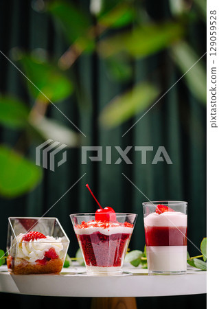 Delicious desserts in stylish glasses presented on a table Delicious desserts in stylish glasses presented on a table 129059528