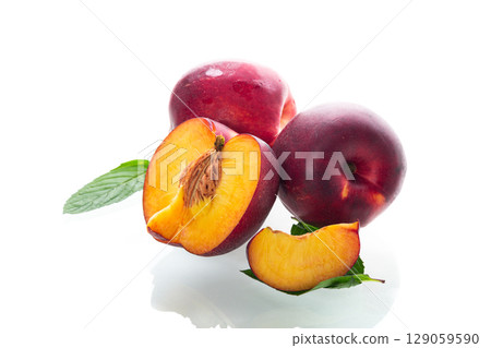 Ripe juicy nectarines isolated on white background 129059590