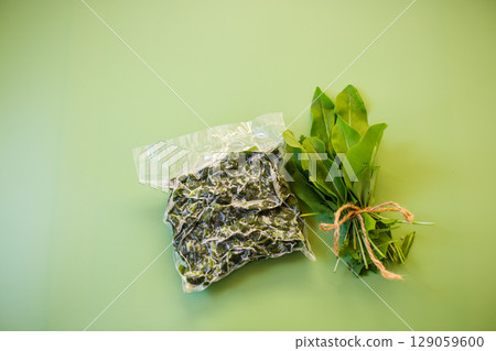 Frozen sorrel in a bag and a bunch of fresh sorrel 129059600