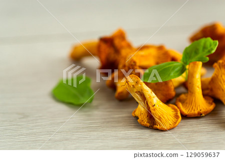 bowl with wild chanterelle mushrooms on a wooden table 129059637