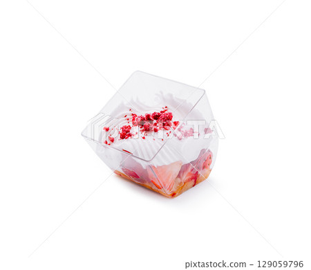 Delicious strawberry dessert served in a clear plastic cup with cream 129059796