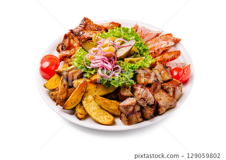 Savory platter featuring grilled meats, fresh vegetables, and seasoned potatoes Savory platter featuring grilled meats, fresh vegetables, and seasoned potatoes 129059802