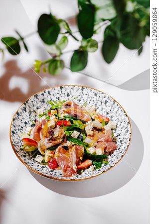 Vibrant salad with prosciutto and fresh veggies in a stylish bowl Vibrant salad with prosciutto and fresh veggies in a stylish bowl 129059864