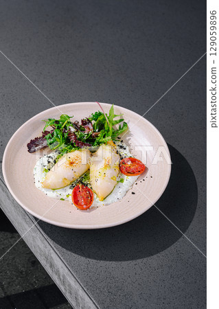 Fresh seafood dish served on a minimalistic plate at a modern restaurant Fresh seafood dish served on a minimalistic plate at a modern restaurant 129059896