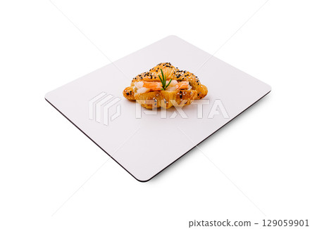 Freshly baked pastry topped with seafood and herbs ready to enjoy 129059901