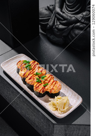 Delicious sushi platter featuring grilled seafood and pickled vegetables 129060074