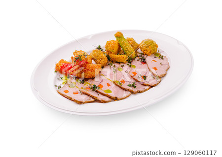 Savory sliced roast meat served with crispy vegetable bites on a platter Savory sliced roast meat served with crispy vegetable bites on a platter 129060117