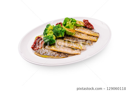 Delicious seared fish with steamed broccoli and sun-dried tomatoes on a plate Delicious seared fish with steamed broccoli and sun-dried tomatoes on a plate 129060118
