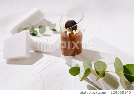 Elegant dessert presentation with chocolate and garnishing elements 129060140