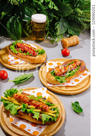 Delicious hot dogs served with fresh ingredients and cold beer in nature 129060201