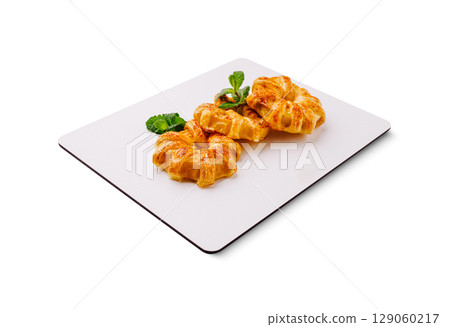 Delicious freshly baked pastries arranged elegantly on a serving board Delicious freshly baked pastries arranged elegantly on a serving board 129060217
