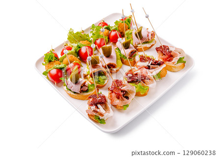 Delicious assortment of appetizers featuring various toppings and garnishes 129060238