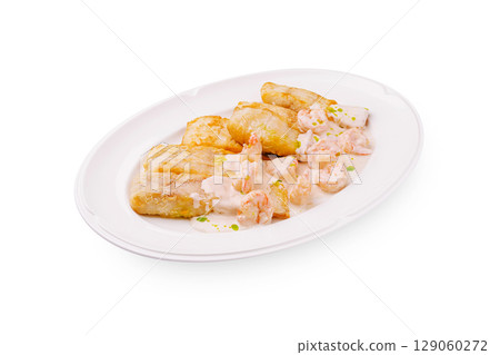 Shrimp with creamy sauce served with fried plantains in a restaurant Shrimp with creamy sauce served with fried plantains in a restaurant 129060272