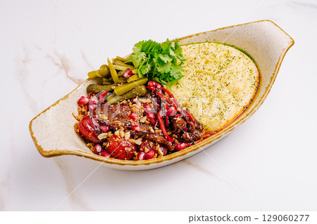 Delicious plate of traditional dish with vibrant ingredients served in a bowl 129060277