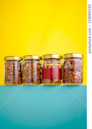 Colorful display of jars filled with granola against a bright background Colorful display of jars filled with granola against a bright background 129060293