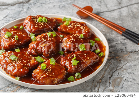 Sweet and sour pork chops are delicious and covered in a glaze made out of brown sugar, soy sauce, hoisin and Worcestershire sauce closeup on the plate. Horizontal Sweet and sour pork chops are delicious and covered in a glaze made out of brown sugar, soy sauce, hoisin and Worcestershire sauce closeup on the plate. Horizontal 129060484