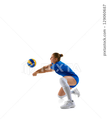 Female volleyball player diving to hit ball against white background Female volleyball player diving to hit ball against white background 129060687