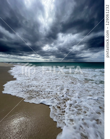 Dramatic storm clouds over a tropical Caribbean Aruba beach 129061232