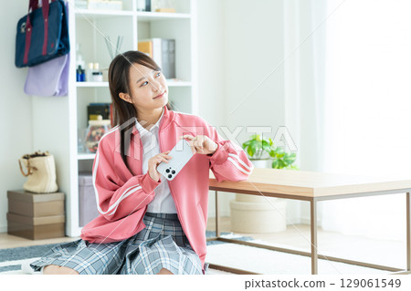 High school girl relaxing in a room High school girl relaxing in a room 129061549