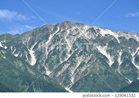 Summer sky and remaining snow on the Hakuba mountain range, Mount Shirouma, Nagano Prefecture 129061582