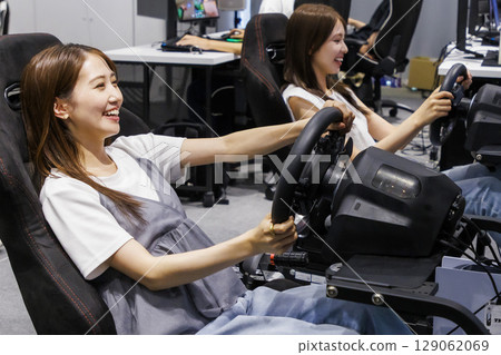 A woman using an eSports driving simulator A woman using an eSports driving simulator 129062069