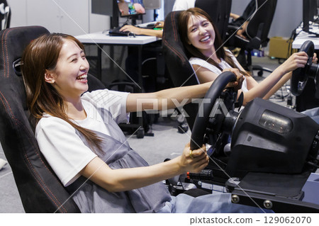 A woman using an eSports driving simulator A woman using an eSports driving simulator 129062070