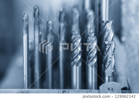Close-up scene the used bull nose or radius end mill tools in the blue tone scene. Close-up scene the used bull nose or radius end mill tools in the blue tone scene. 129062142