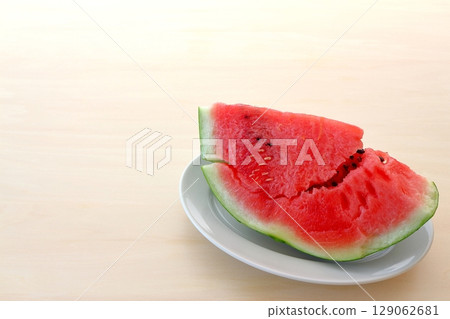 Cut watermelon on the table background 129062681
