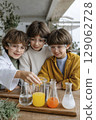 Children conducting science experiment with colorful liquids in laboratory setting engaging learning 129062728